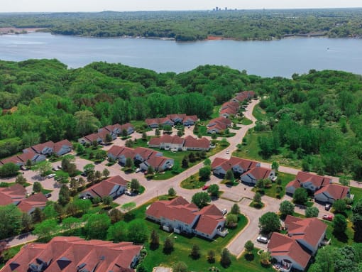 an aerial view of a neighborhood with a body of water