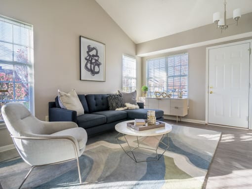 a living room with a couch and chairs and a table