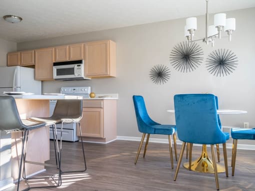 a kitchen and dining room with a table and chairs