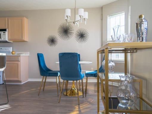 a dining room with a table and chairs and a chandelier