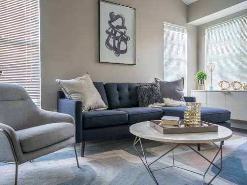 a living room with a blue couch and a coffee table