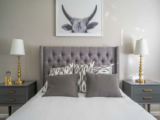 a bedroom with a bed and a picture of a bull