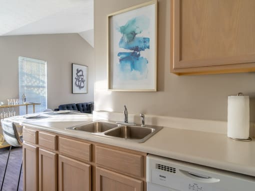 a kitchen with a sink and a window and a living room