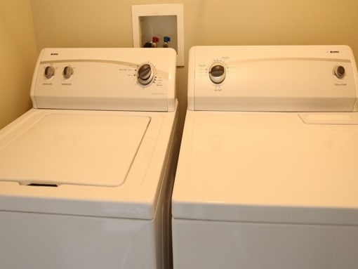 two washing machines are lined up next to each other