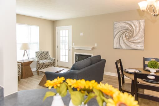 a living room with a couch and a table with flowers