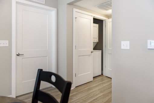 a black chair in a room with white doors