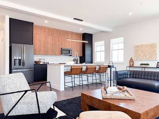 A modern kitchen with a black and white chair.