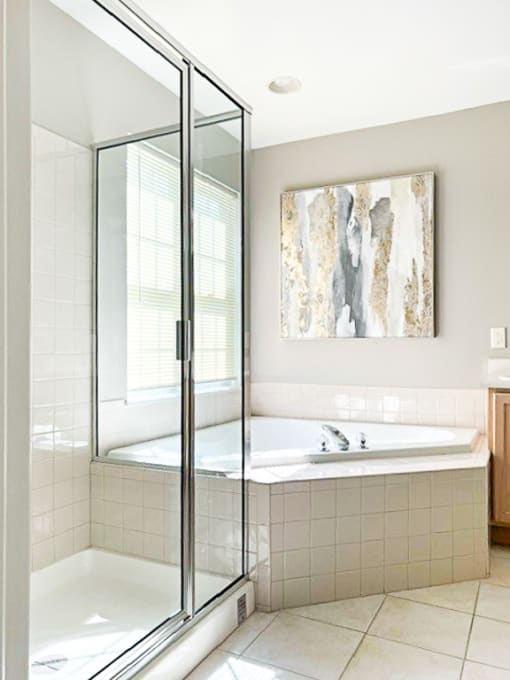 Primary bathroom with soaking tub and step-in shower (available in select units)