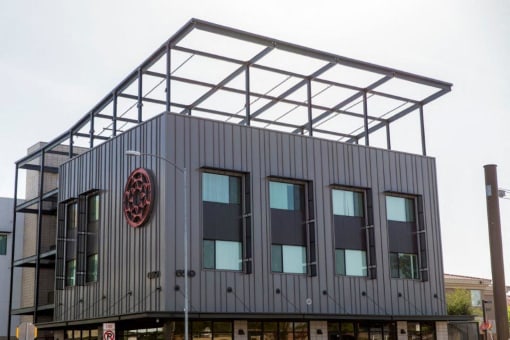 a building with windows and a logo on the side of it