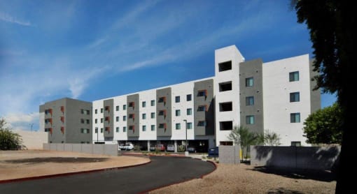 a large white building with a street in front of it