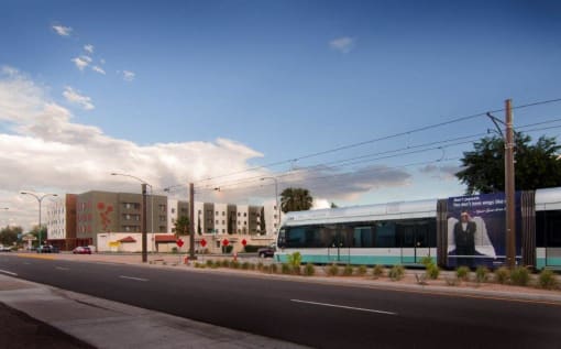 a bus driving down a street next to a building