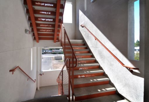 a set of stairs with a railing and a window