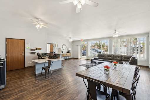 A dining room with a wooden table and chairs.