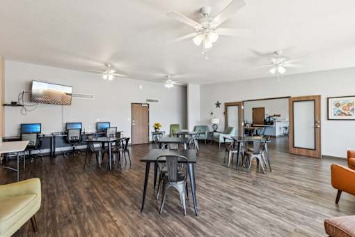A room with wooden floors and a ceiling fan.