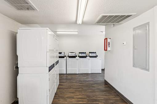 A white kitchen with a white fridge and white oven.