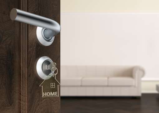 a door with a house key on the door handle