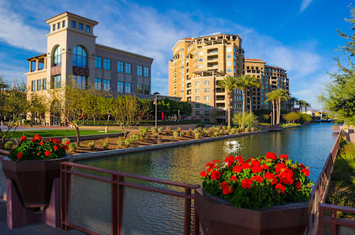 a bridge over a river with buildings in the background
