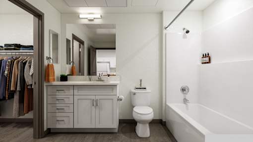 A white bathroom with a toilet, sink, and bathtub.