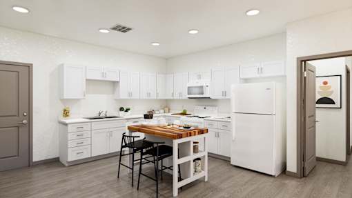 A kitchen with white cabinets and a wooden island.