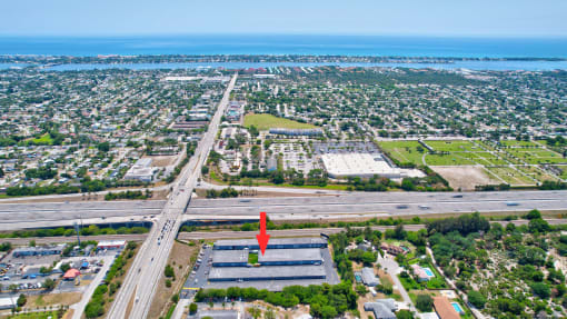 an aerial view of a city with an arrow pointing to the ocean
