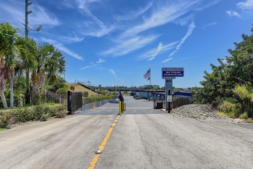 a highway with a bridge over a body of water with palm trees