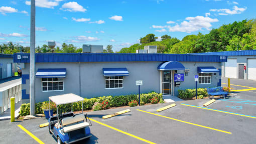 a blue building with a parking lot and a blue roof