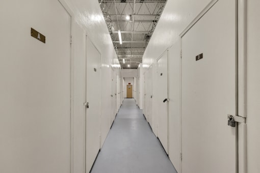 a row of white lockers in a prison hallway