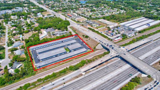 an aerial view of an industrial area with highways and buildings