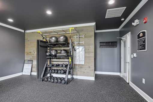 A gym room with a rack of weights and a sign that say at Venue at 109 Apartments, Lebanon , Tennessee