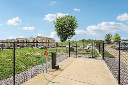 A playground with a swing set and a fence at Venue at 109 Apartments, Lebanon , TN