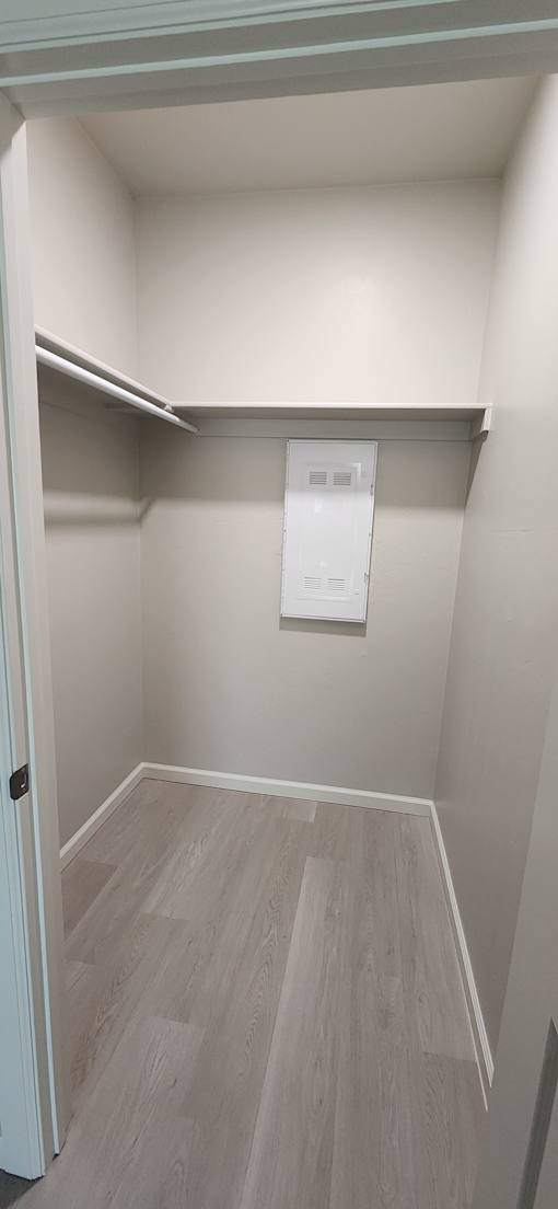 A white room with a door open to a hallway.
