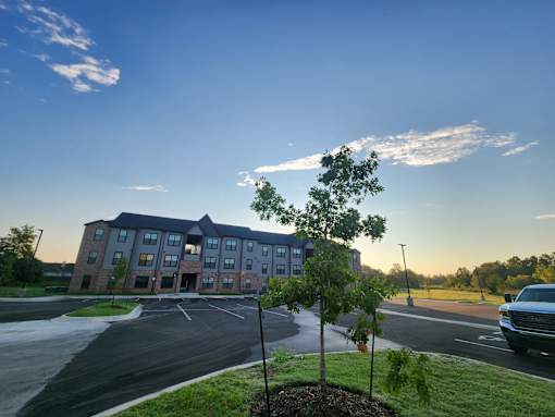 A large building with a parking lot in front of it.