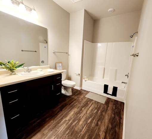 A bathroom with a toilet, sink, and bathtub.