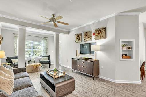 A living room with a grey sofa and a wooden coffee table.