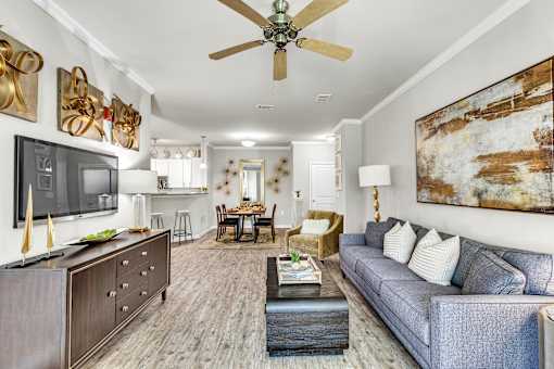 A living room with a grey couch and a wooden coffee table.