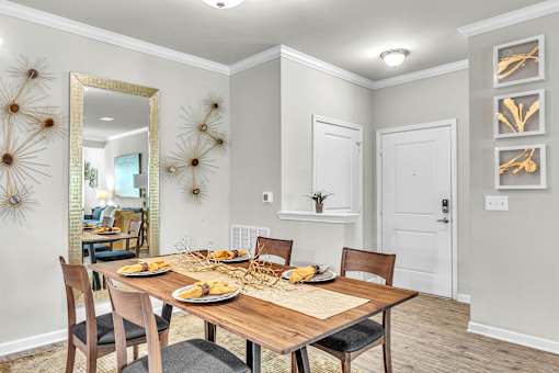 A dining room with a wooden table set for a meal.