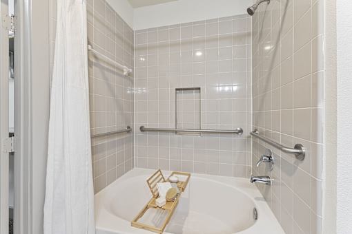 A white bathroom with a white tub and a white shower curtain.