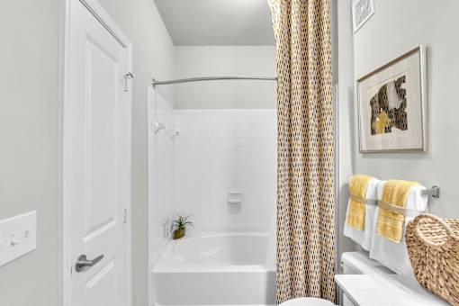 A bathroom with a white tub and a white door.