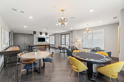 A modern dining room with a large table and chairs.