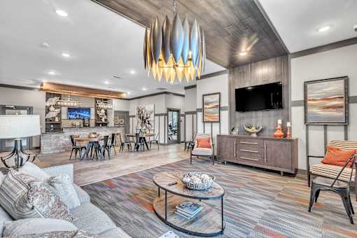 A modern living room with a grey sofa and a wooden coffee table.