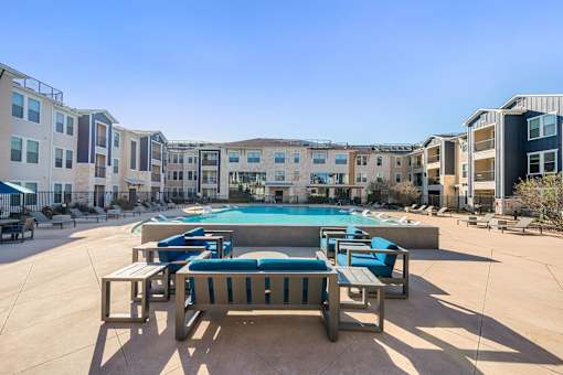 Pool surrounded by chairs at Edge and Stone, San Antonio