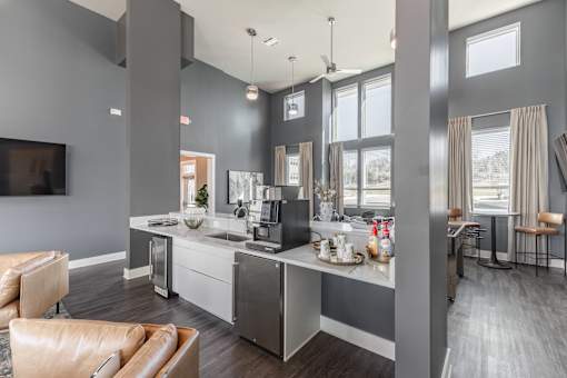 A modern kitchen with a large island and a flat-screen TV mounted on the wall at Prosper Madison Oaks, Madison, AL