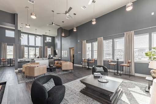 A modern living room with a black chair and a coffee table at Prosper Madison Oaks, Madison