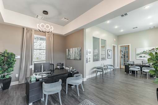 A modern home office with a desk, chairs, and a computer at Prosper Madison Oaks, Madison, AL