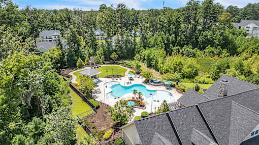 A large backyard with a pool and a deck.