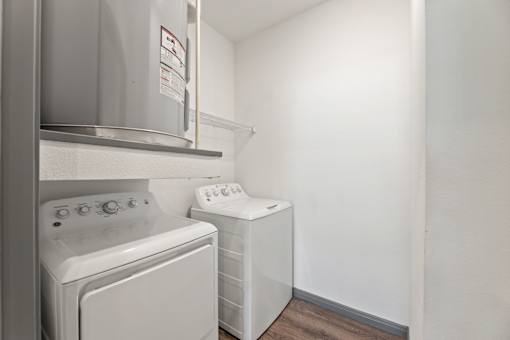 A white washing machine and dryer in a small laundry room.