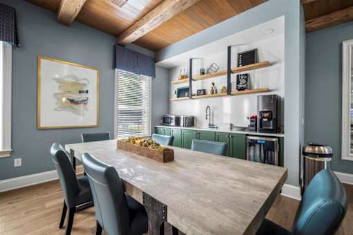 A dining room with a wooden table and chairs.
