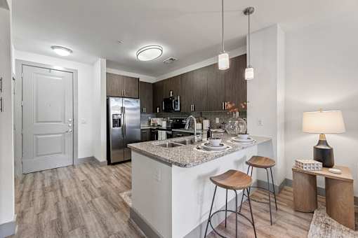 A kitchen with a white countertop and a sink.
