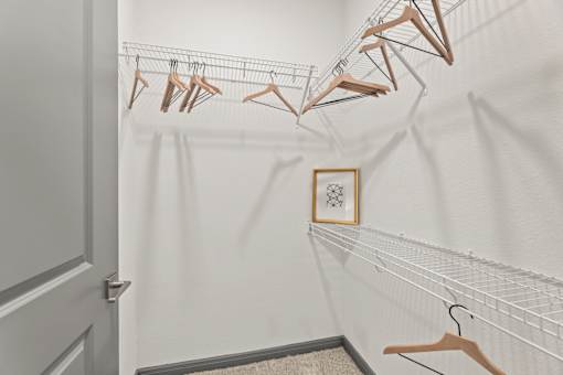 A row of clothes hangers on a rack in a room.