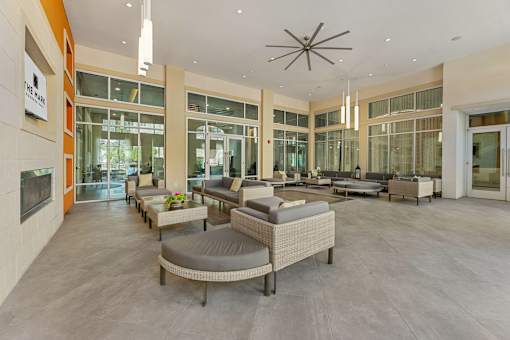 A spacious living room with a fireplace and a large window.